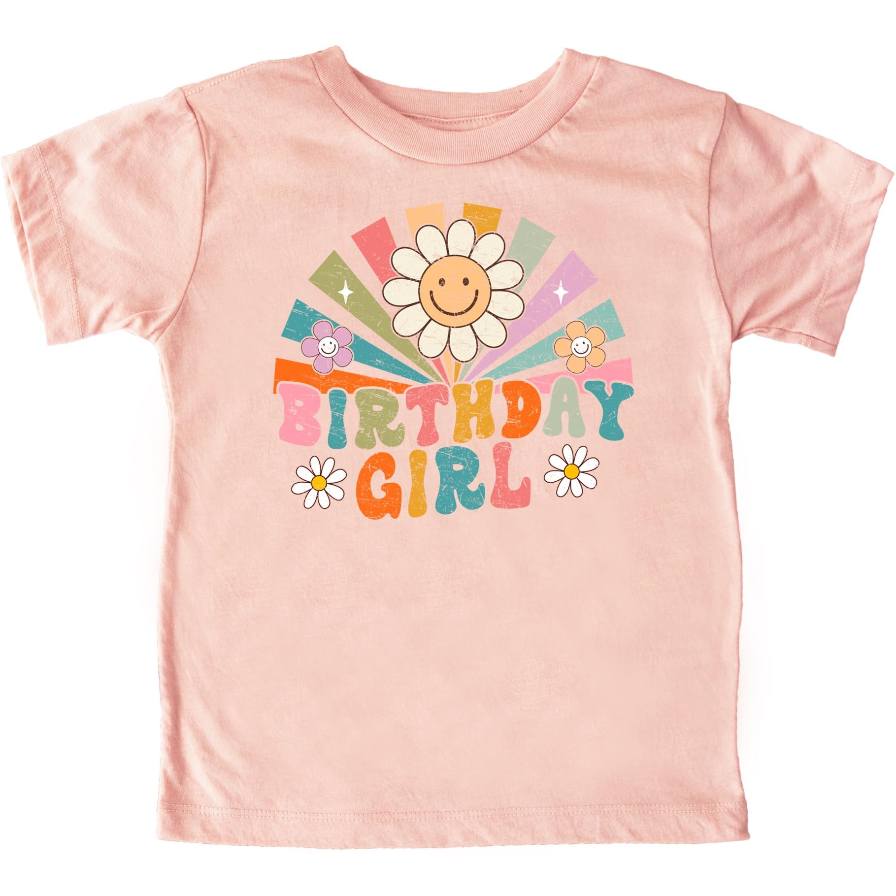 Close-up of vibrant rainbow sunbeam and groovy flower design on girls birthday tee
