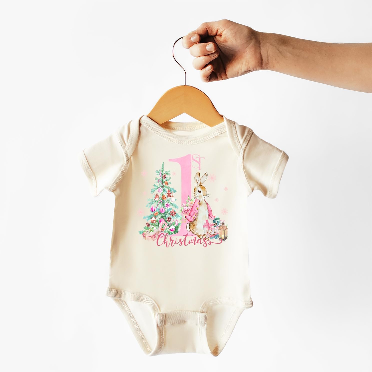 Flat lay of 1st Christmas bunny bodysuit for baby girl on a light background