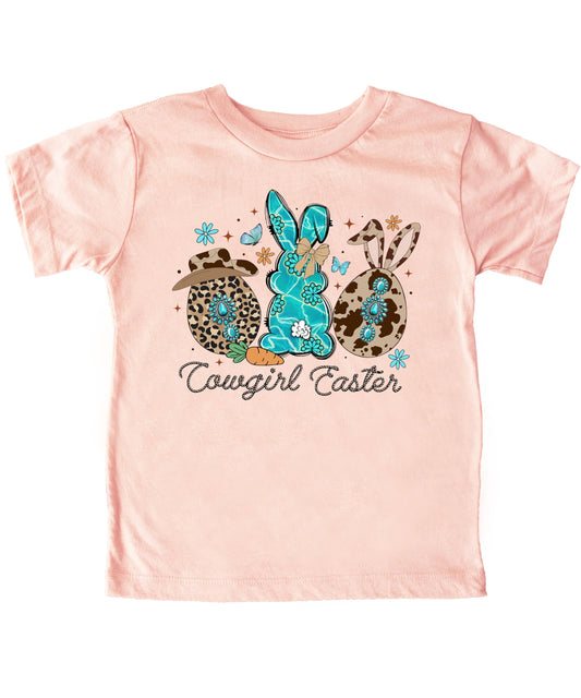 Women's peach cowgirl Easter shirt with cow print bunny graphic and 'Cowgirl Easter' text on front