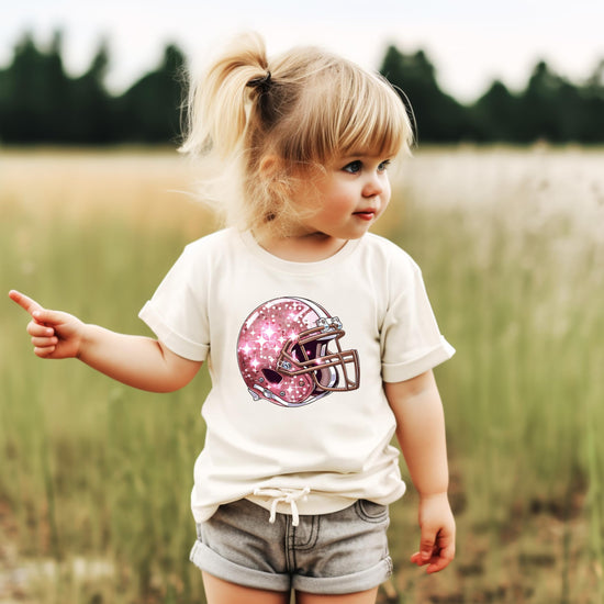 Girls modeling pink football helmet graphic tee in natural color