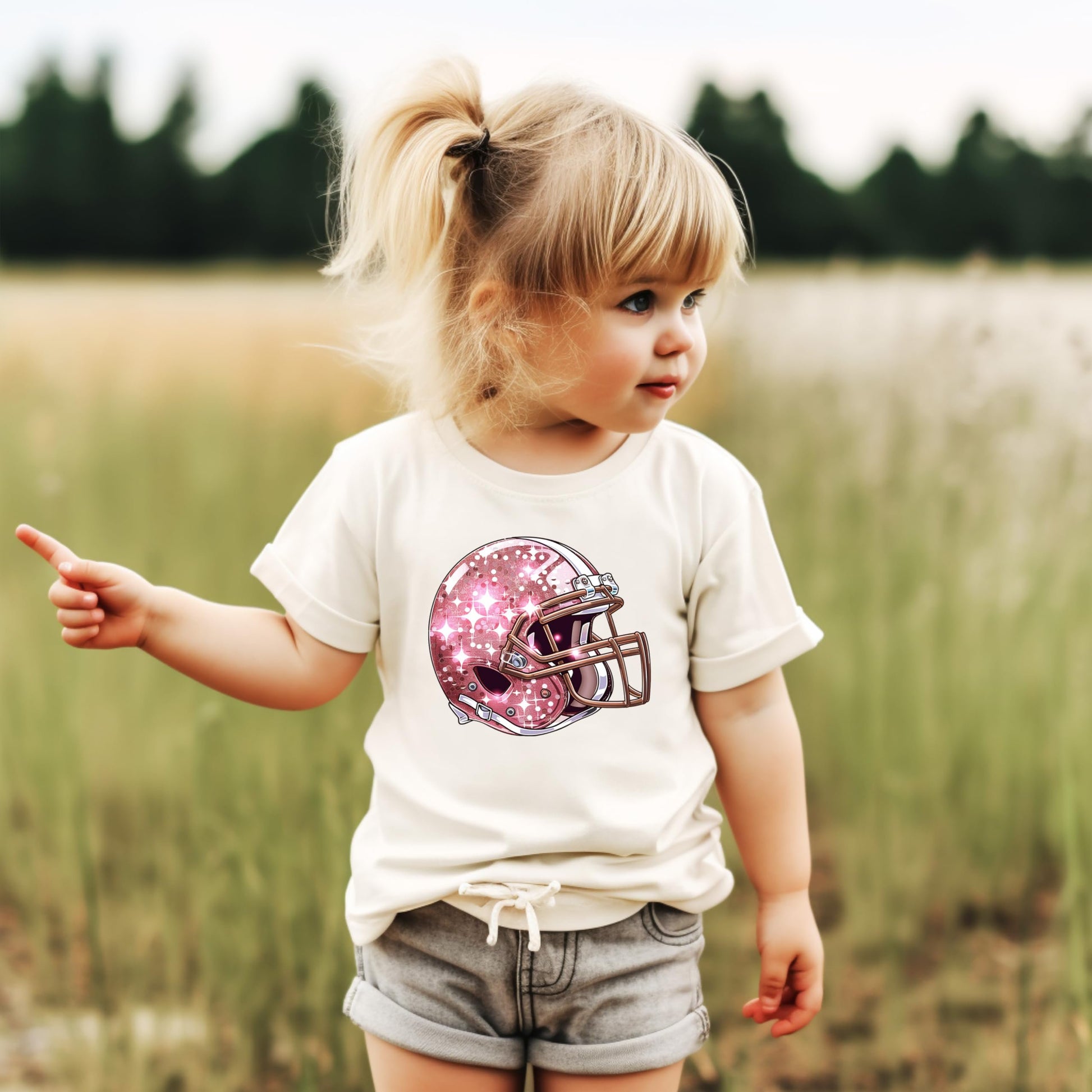 Girls modeling pink football helmet graphic tee in natural color