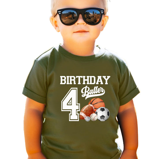 Young boy wearing 4th birthday sports theme graphic tee in granite heather color