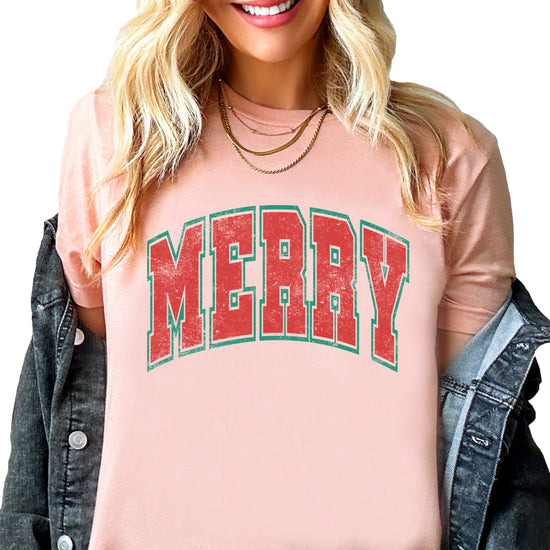Close-up of Merry varsity letters design printed on a natural unisex Christmas tee