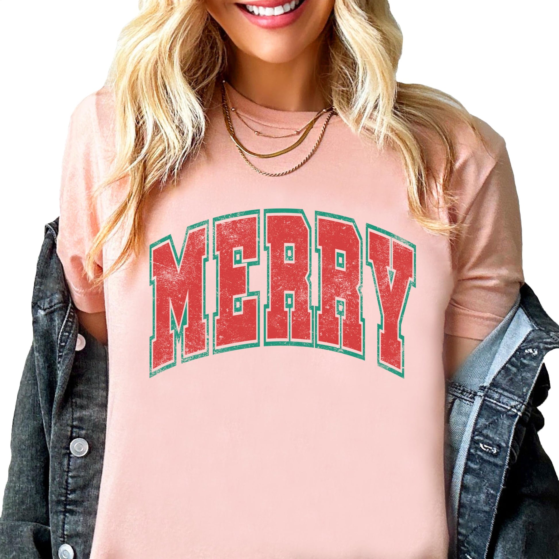 Close-up of Merry varsity letters design printed on a natural unisex Christmas tee