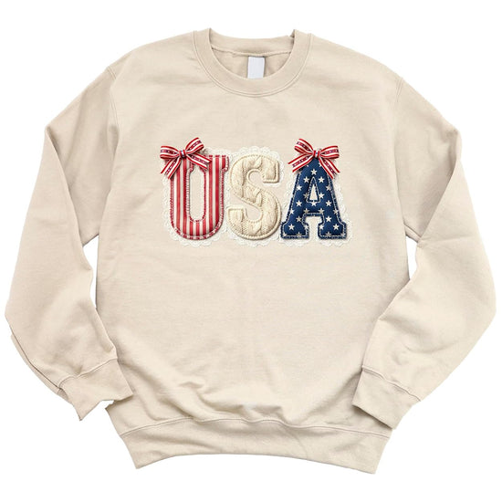 Flat lay of USA coquette sweatshirt showing full design with patriotic bow accents and lace trim