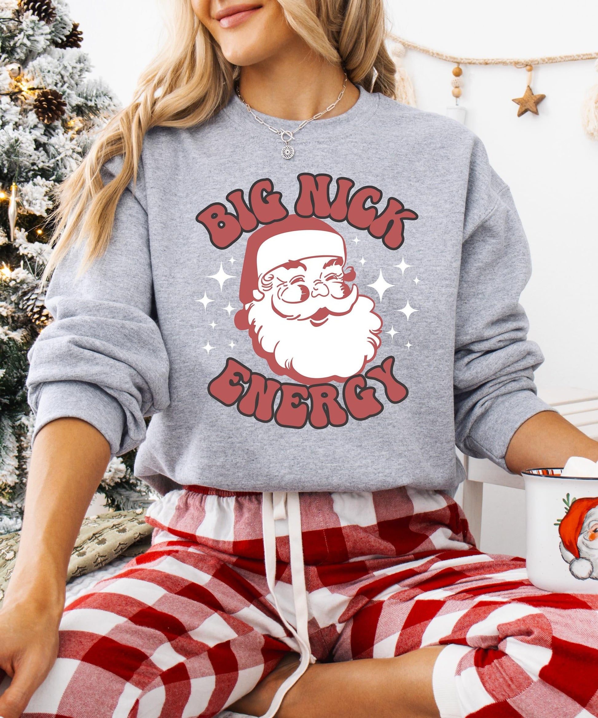Detail shot of soft fleece fabric and holiday Santa print on Big Nick Energy sweatshirt