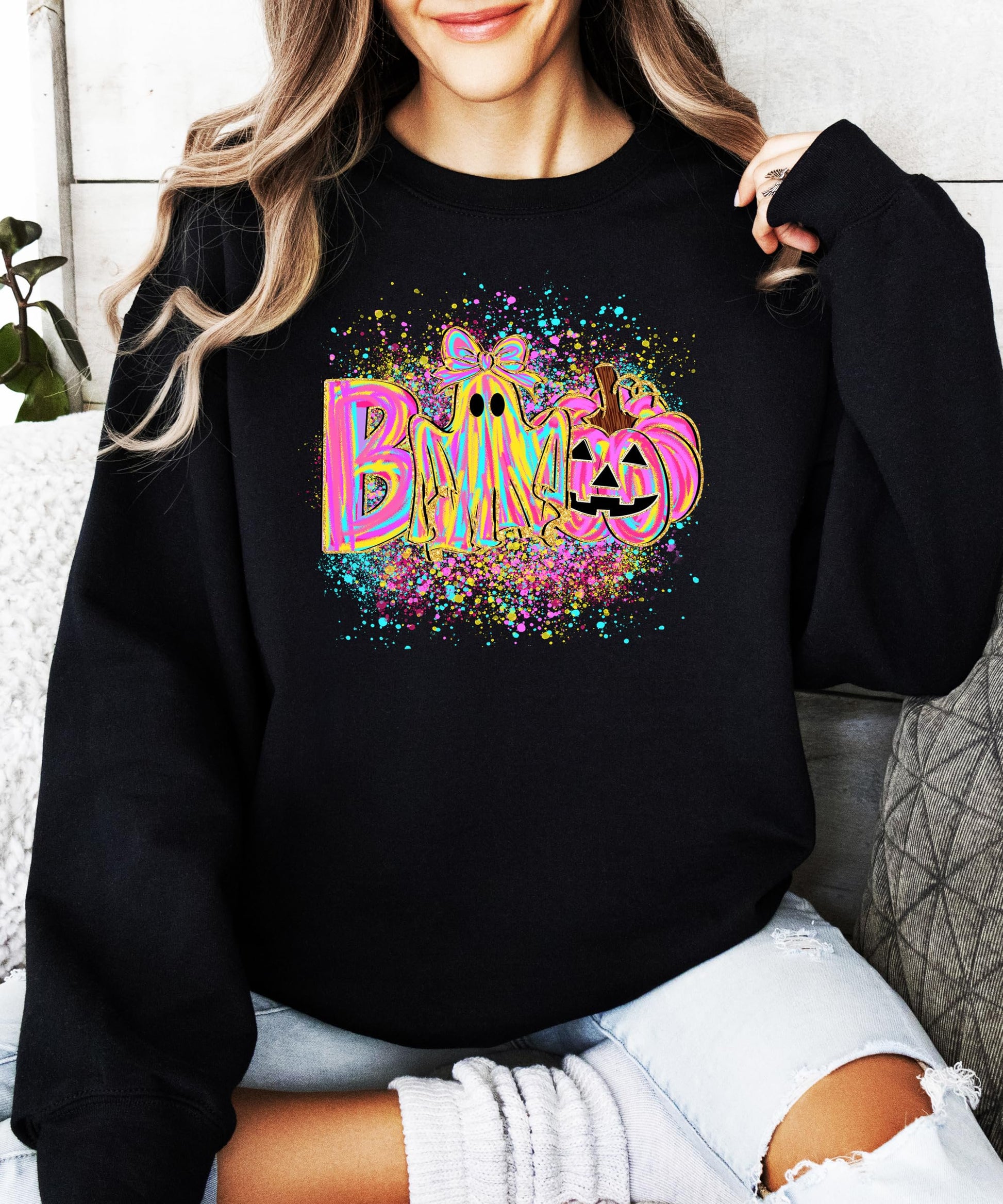 Neon BOO Halloween sweatshirt flat lay showing full ghost and pumpkin graphic print