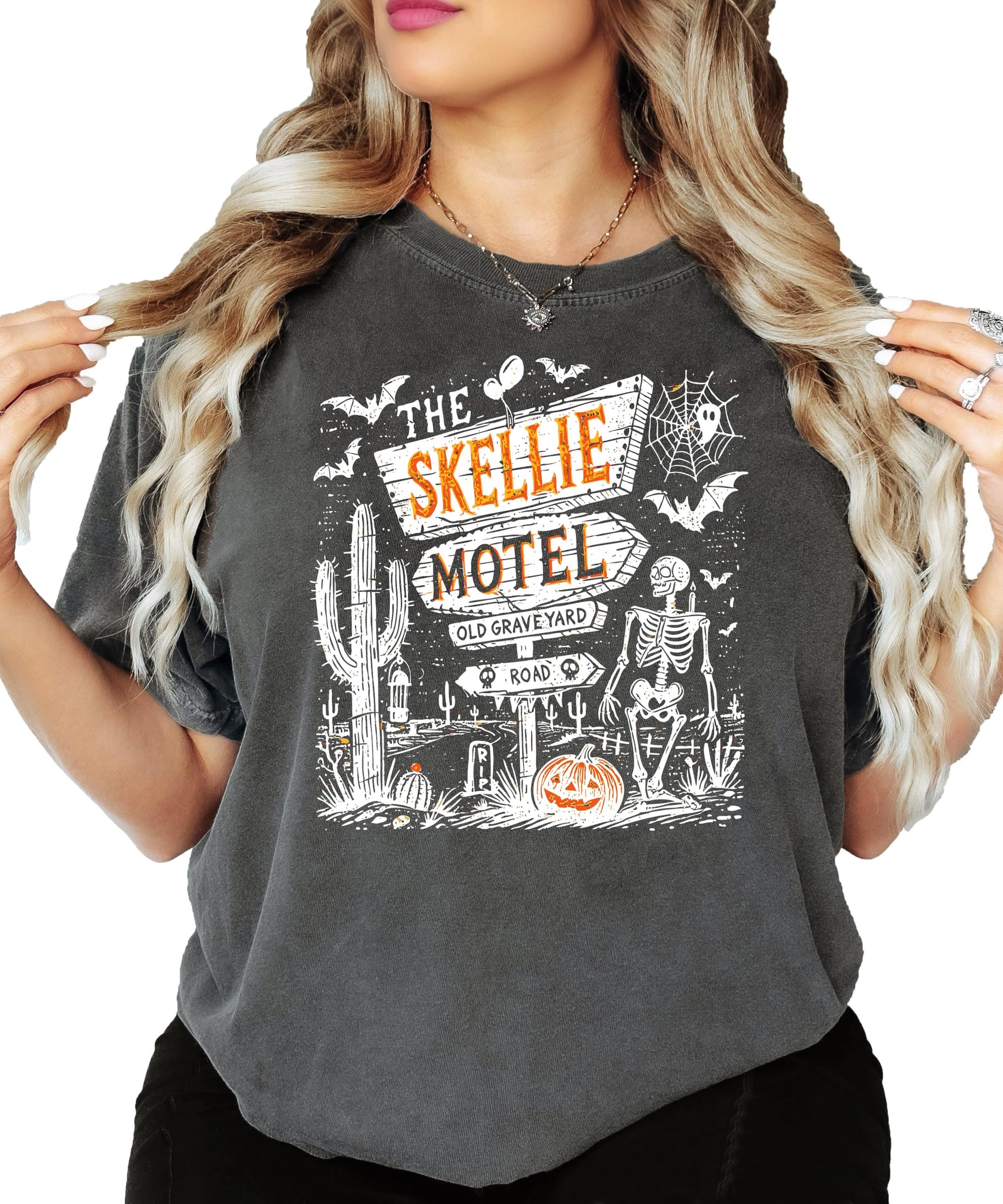 Close-up of Skellie Motel Halloween graphic tee print detail with skeleton, pumpkins, and retro motel sign