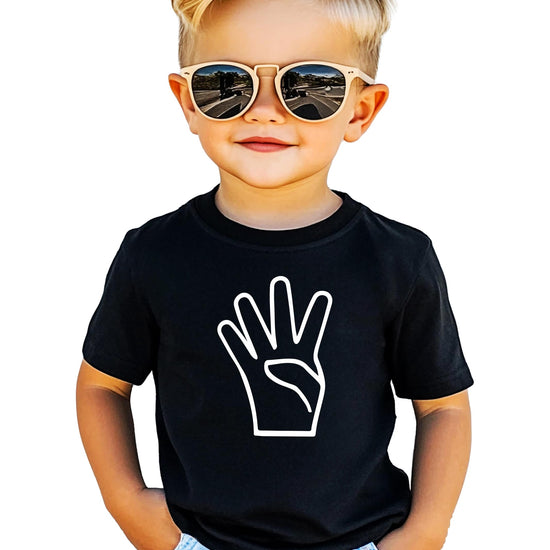 Close-up of vibrant age 4 birthday graphic print on soft black kids t-shirt