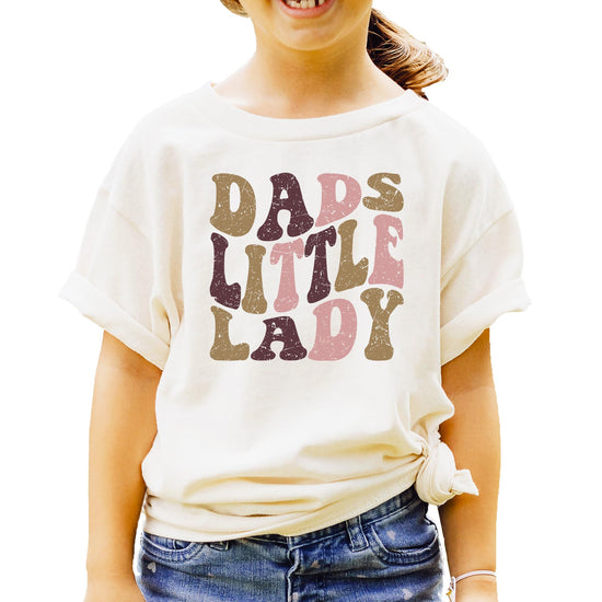 Girls natural tee with retro distressed Dad's Little Lady bubble font graphic in warm vintage colors