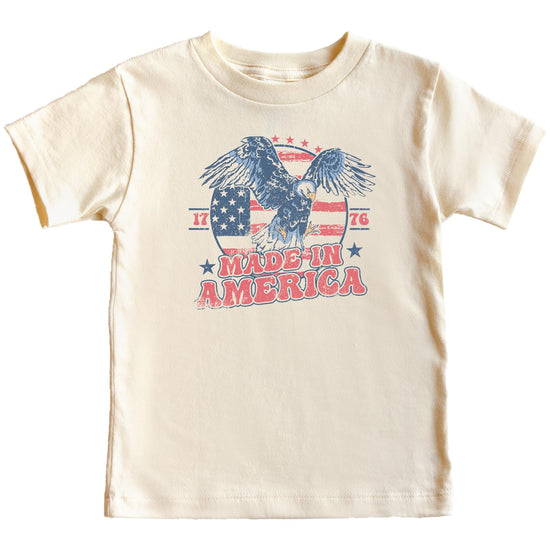 Close-up of vintage eagle and American flag 1776 graphic print on natural cotton tee