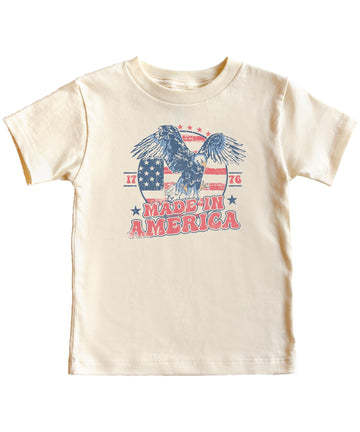Close-up of vintage eagle and American flag 1776 graphic print on natural cotton tee
