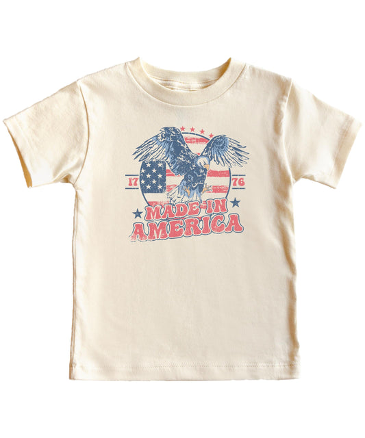 Close-up of vintage eagle and American flag 1776 graphic print on natural cotton tee