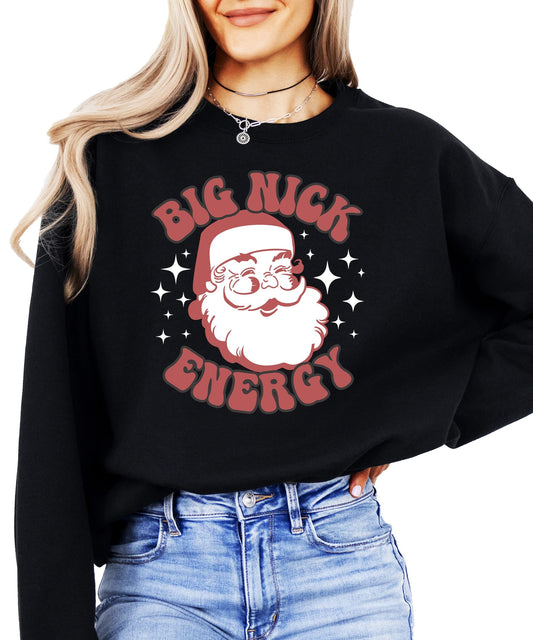 Women's black pullover sweatshirt with retro Big Nick Energy Santa graphic by Olive Loves Apple