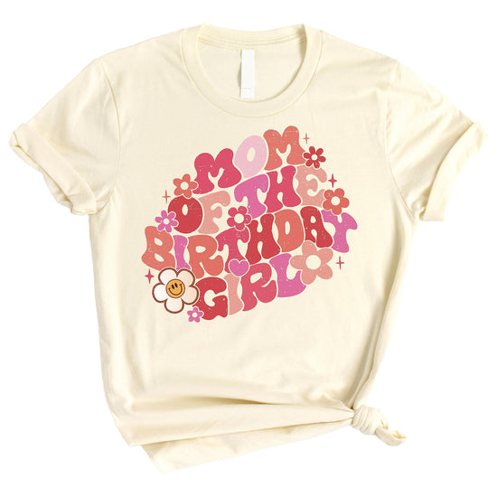 Mommy and me matching groovy daisy birthday shirts laid flat showing natural color and retro design