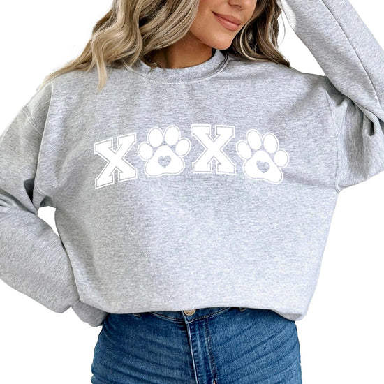 Lifestyle photo of woman wearing animal lover pawprint Valentine's sweatshirt