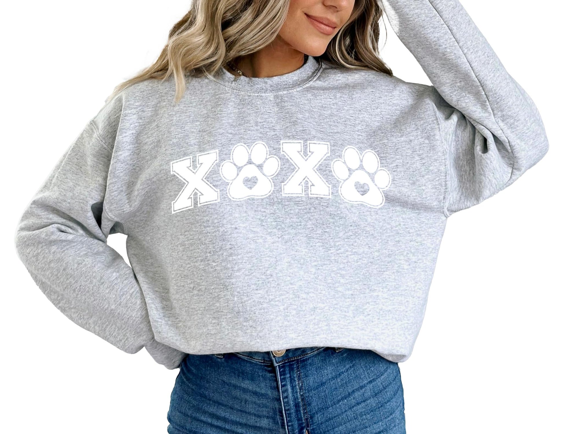 Lifestyle photo of woman wearing animal lover pawprint Valentine's sweatshirt
