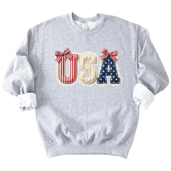 Close-up view of USA coquette design showing lace trim and ribbon bow details on patriotic sweatshirt
