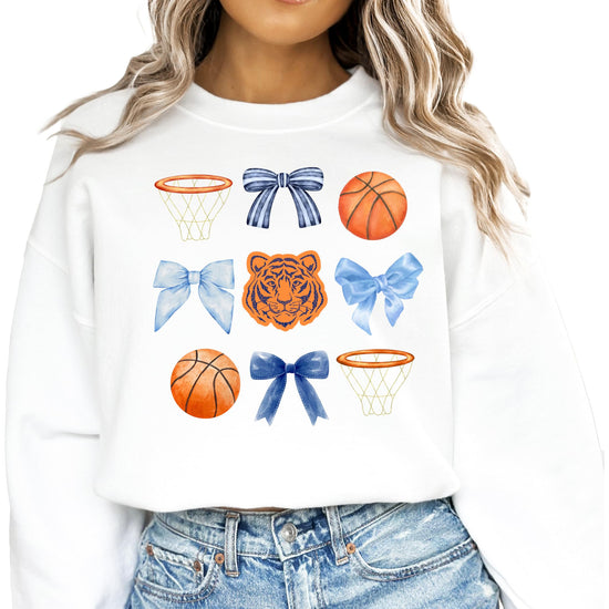 White women's pullover sweatshirt with Tigers mascot, basketballs, and coquette bow graphic design