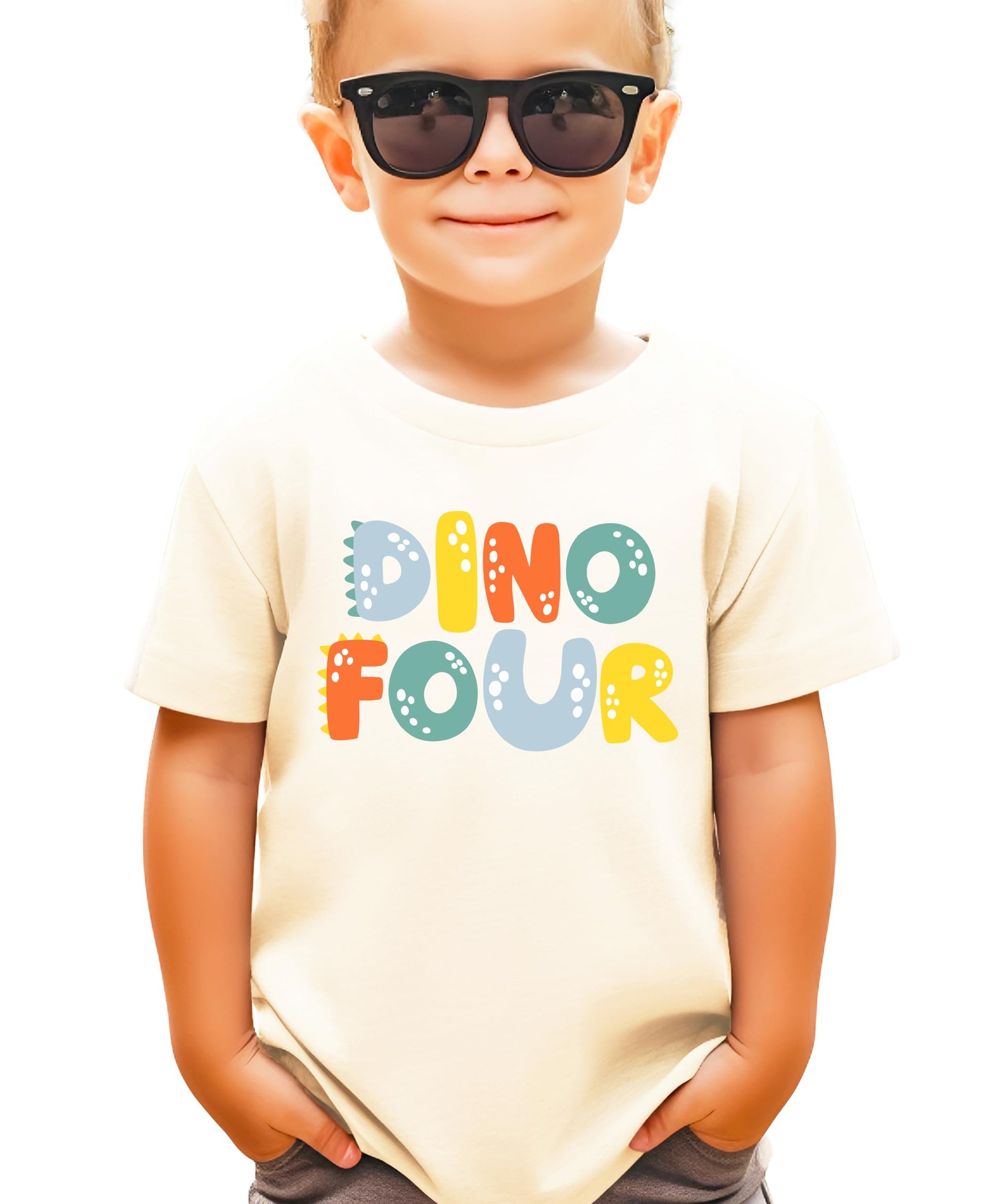 Close-up of Dino Four birthday tee showing vibrant dinosaur print detail