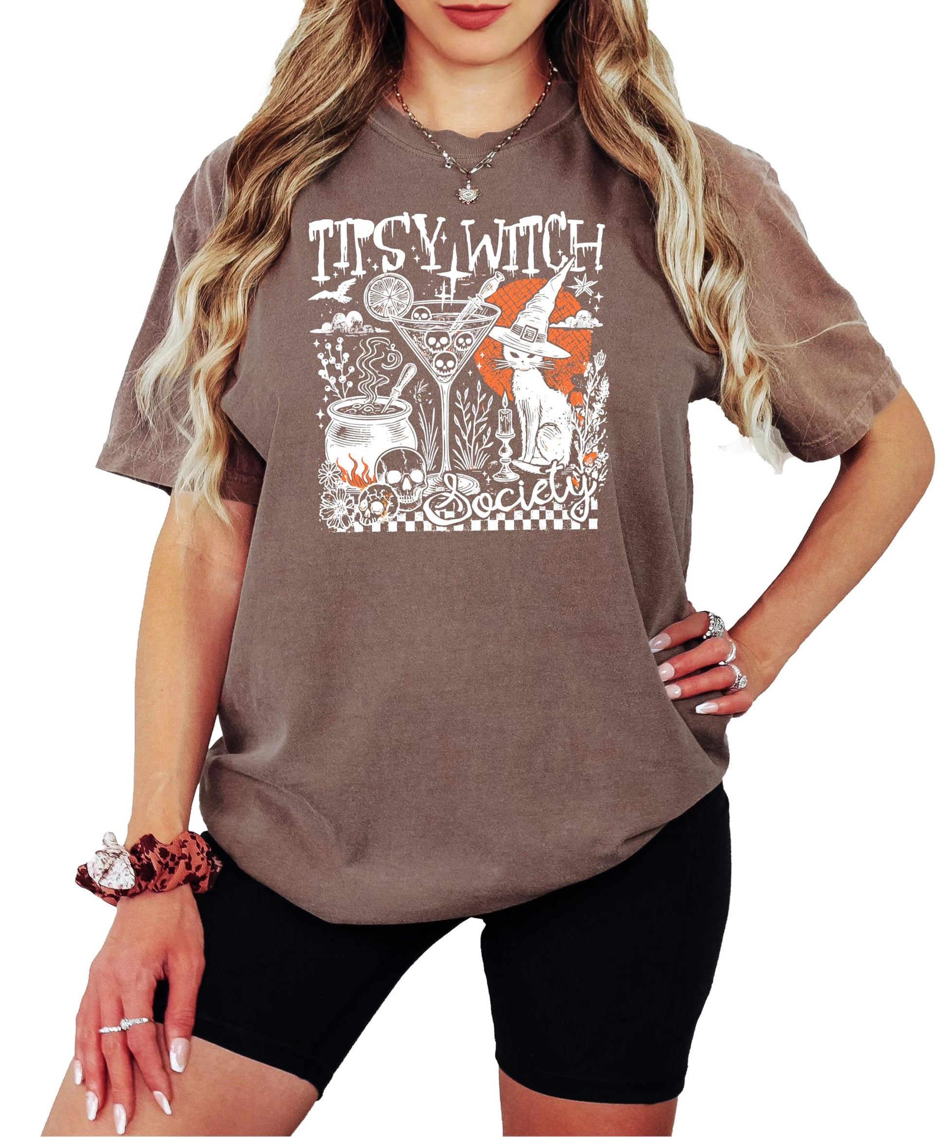 Close-up of Tipsy Witch Society shirt design showing black cat, skull, cocktail glass, and bubbling cauldron details