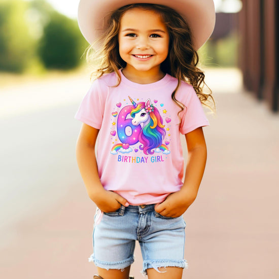 Close-up of rainbow unicorn graphic print on girls 6th birthday tee showing vibrant colors