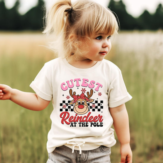 Flat lay of youth girls' natural Christmas shirt with reindeer holiday design