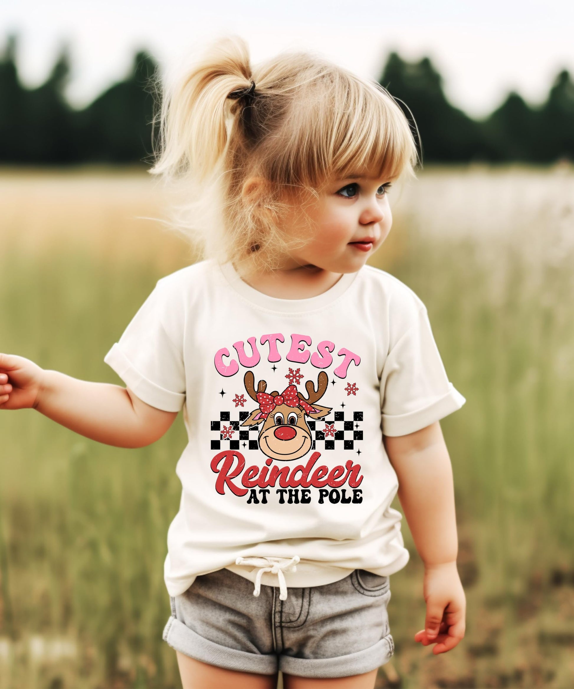 Flat lay of youth girls' natural Christmas shirt with reindeer holiday design