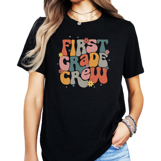 Close-up of bold retro First Grade Crew print on black kids' t-shirt