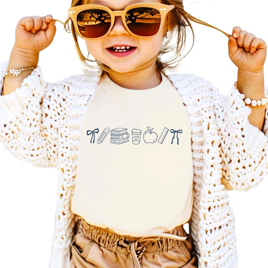 Adult and youth matching coquette bow back to school tees in pink showing teacher and student coordinating look