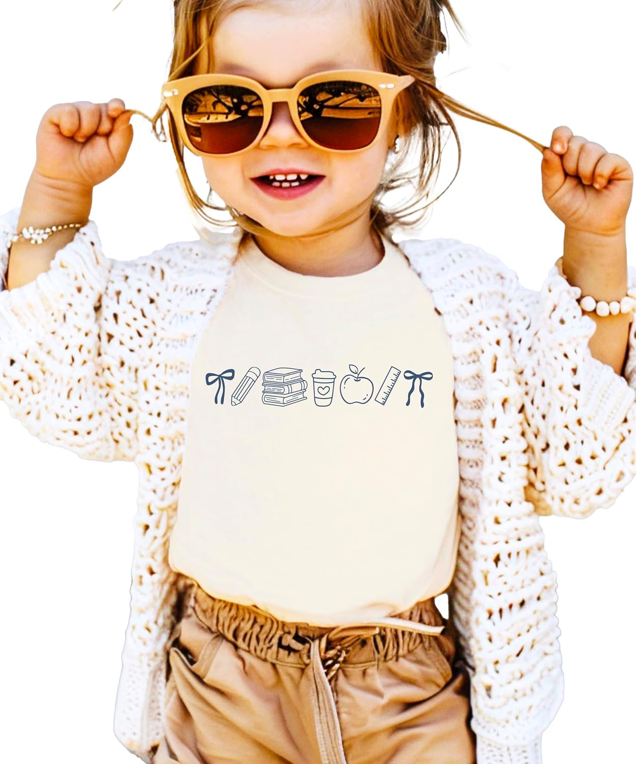 Adult and youth matching coquette bow back to school tees in pink showing teacher and student coordinating look