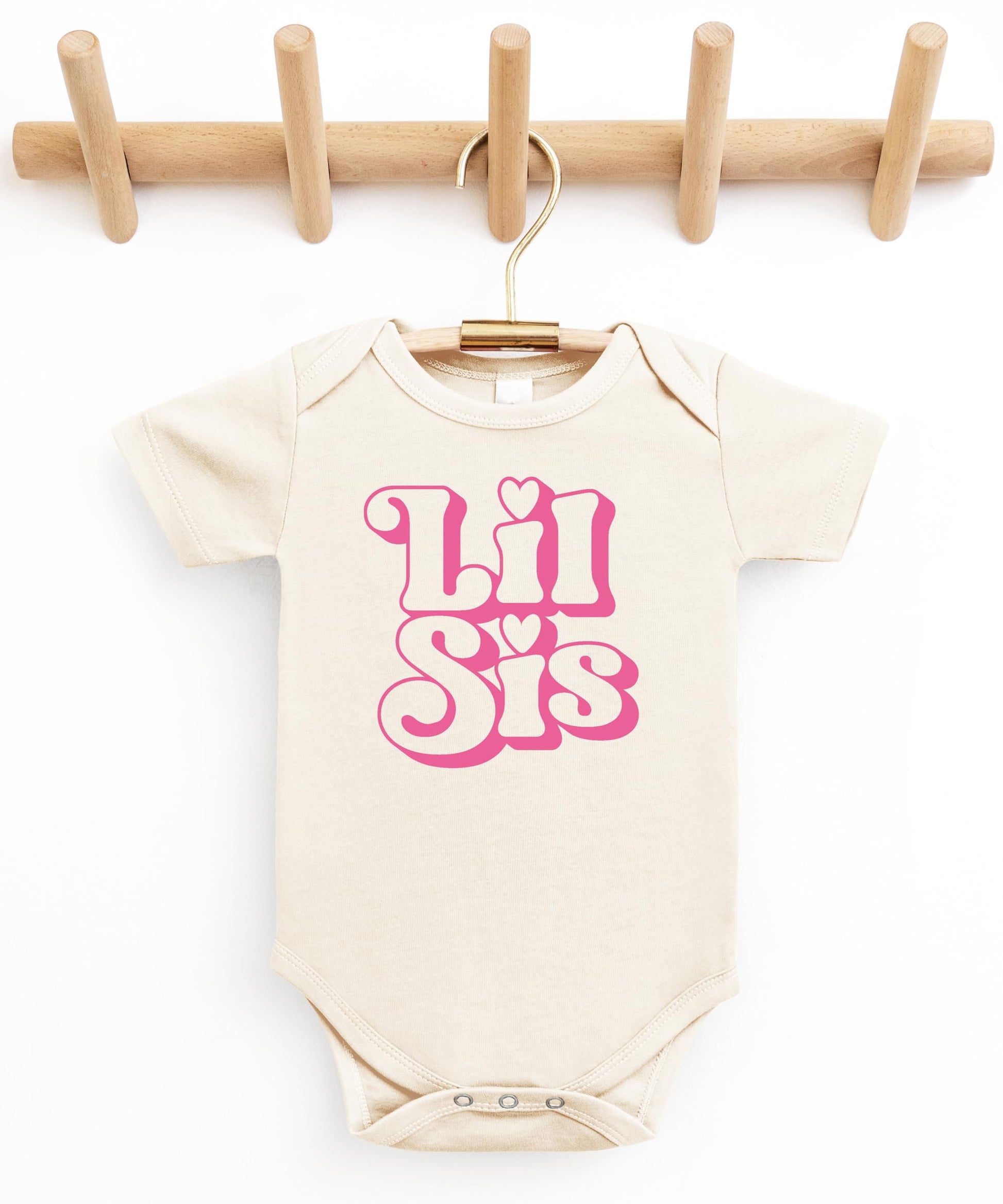 Lil Sis newborn bodysuit displayed as a baby shower gift option for little sister announcement