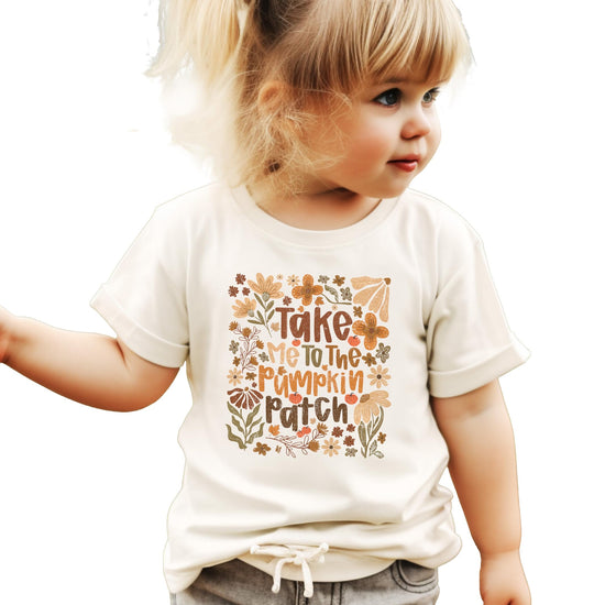 Close-up of pumpkin patch graphic tee showing colorful autumn floral pumpkin print details