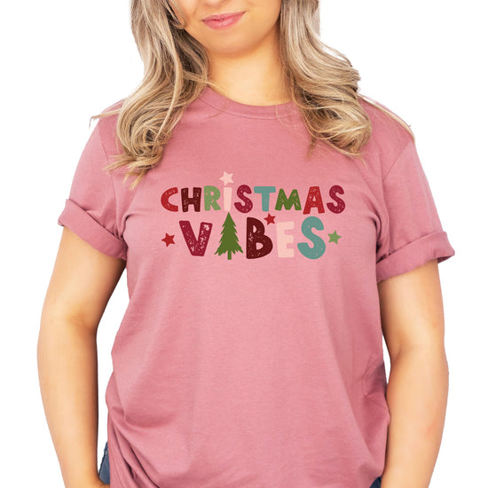 Adult and kids Christmas Vibes matching tee laid flat showing holiday graphic design