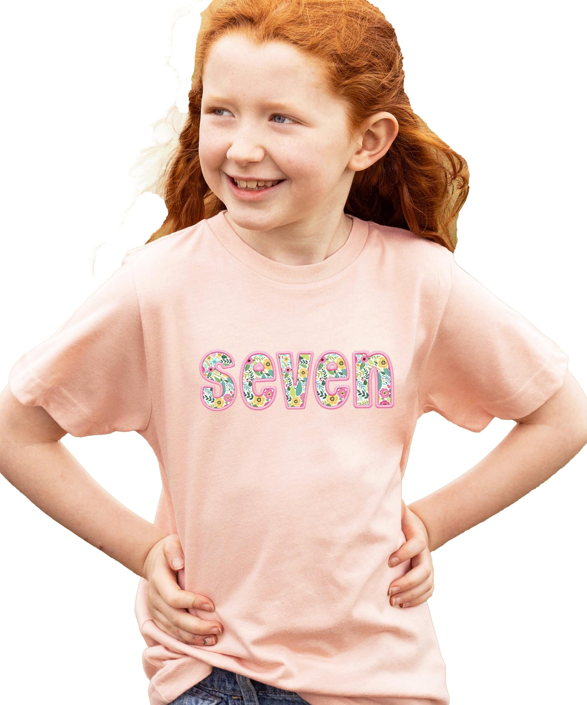 Side view of peach birthday tee with floral seven embroidery detail