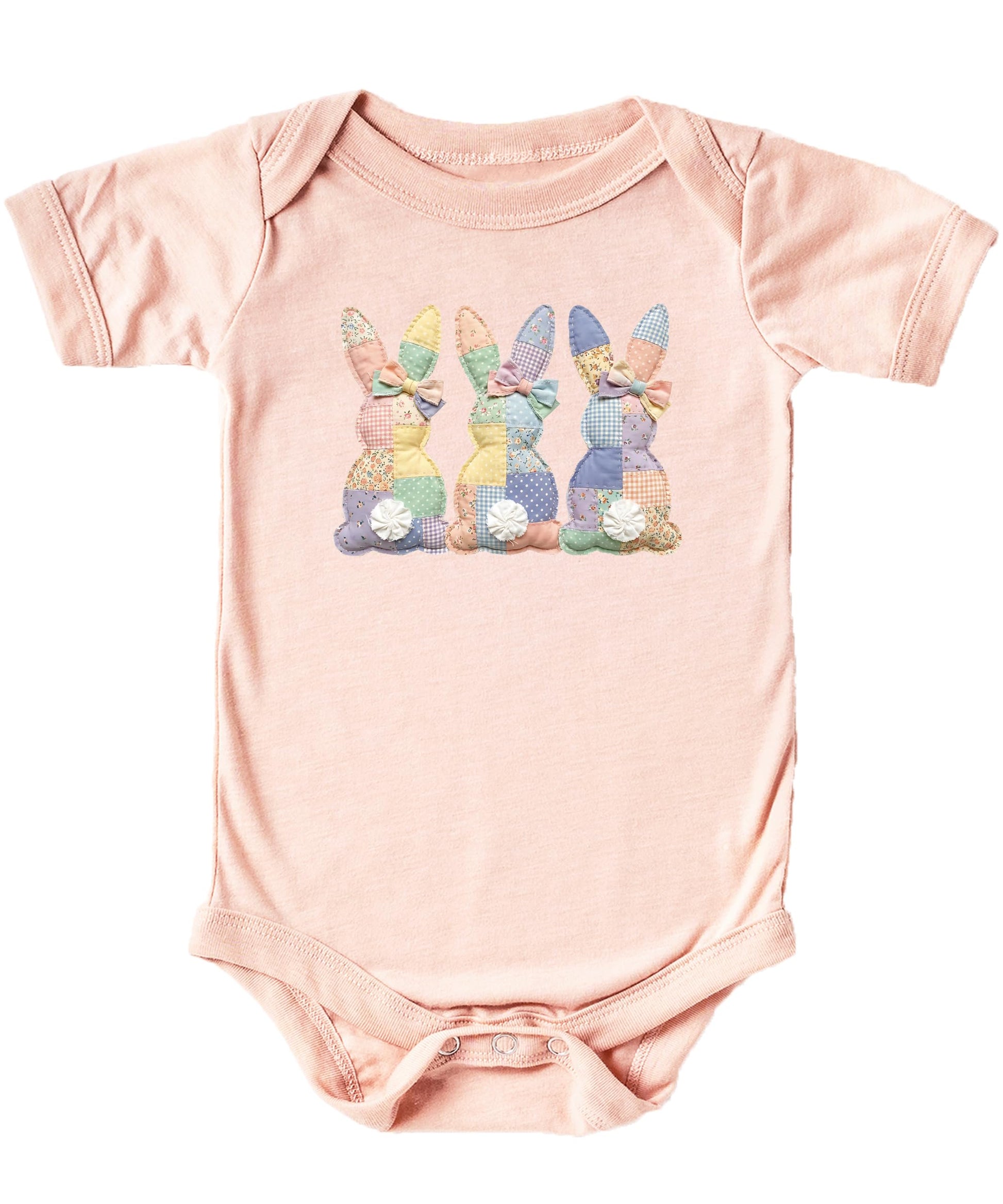 Natural baby bodysuit with three quilt-style bunnies printed in soft spring colors for Easter