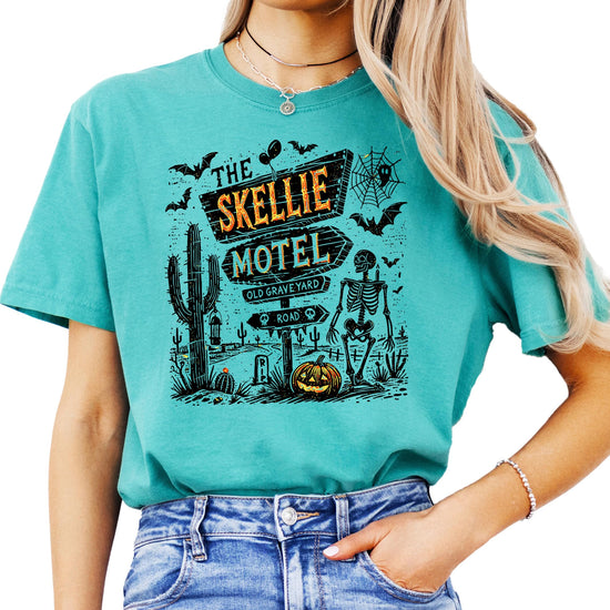 Front view of Skellie Motel Halloween shirt in seafoam showing full skeleton graphic motel artwork