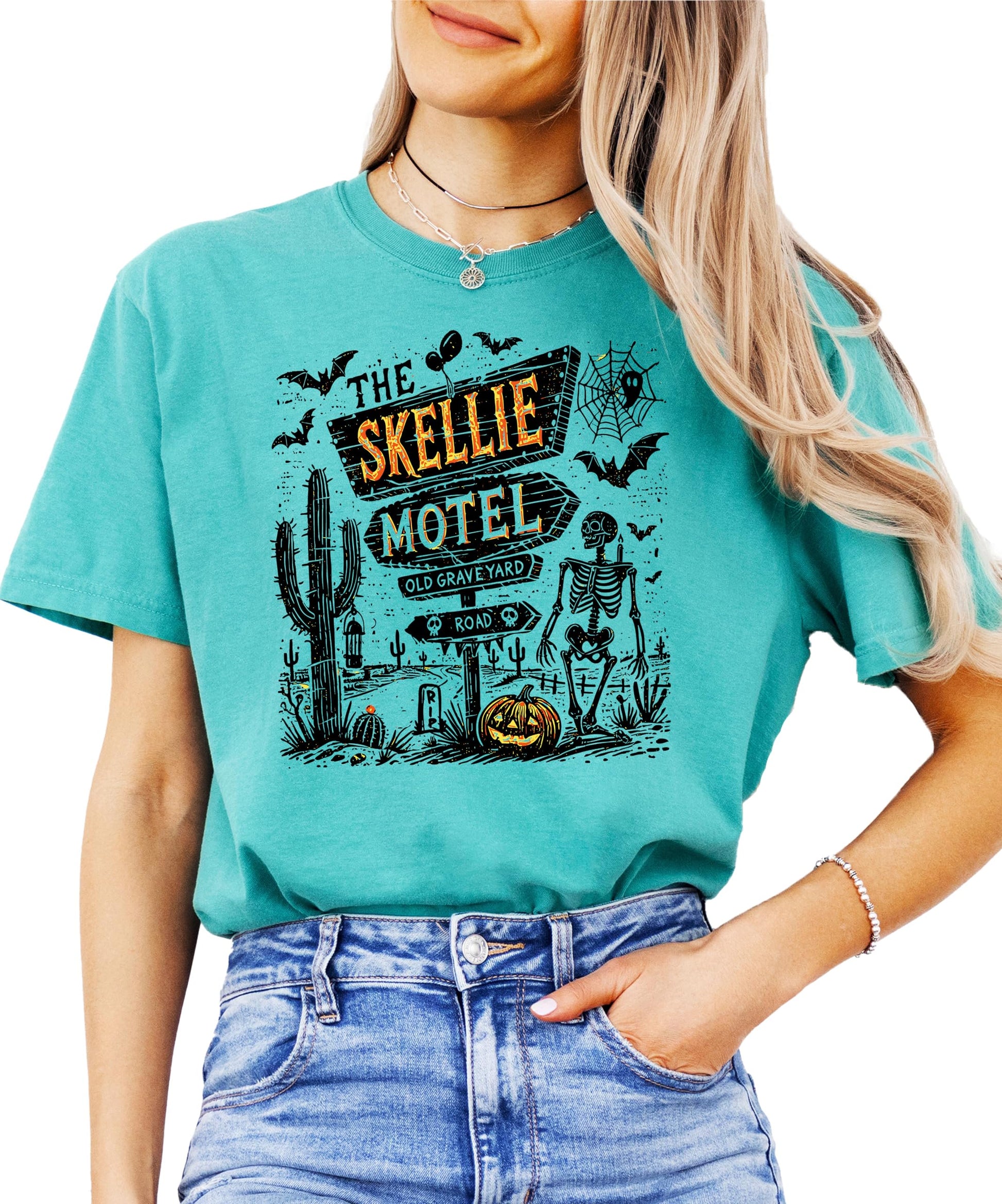 Front view of Skellie Motel Halloween shirt in seafoam showing full skeleton graphic motel artwork