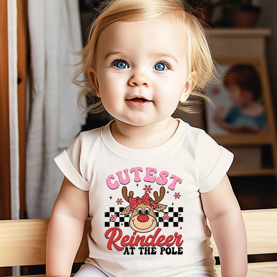 Girls wearing the Cutest Reindeer at the Pole Christmas graphic tee in natural color