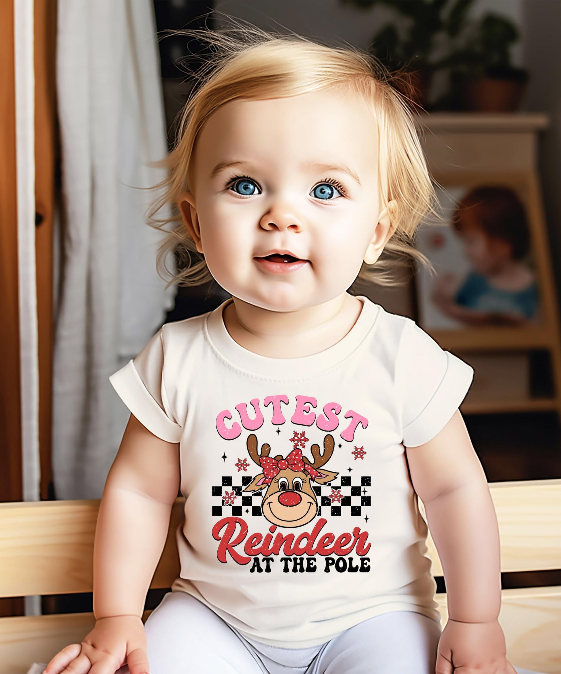 Girls wearing the Cutest Reindeer at the Pole Christmas graphic tee in natural color