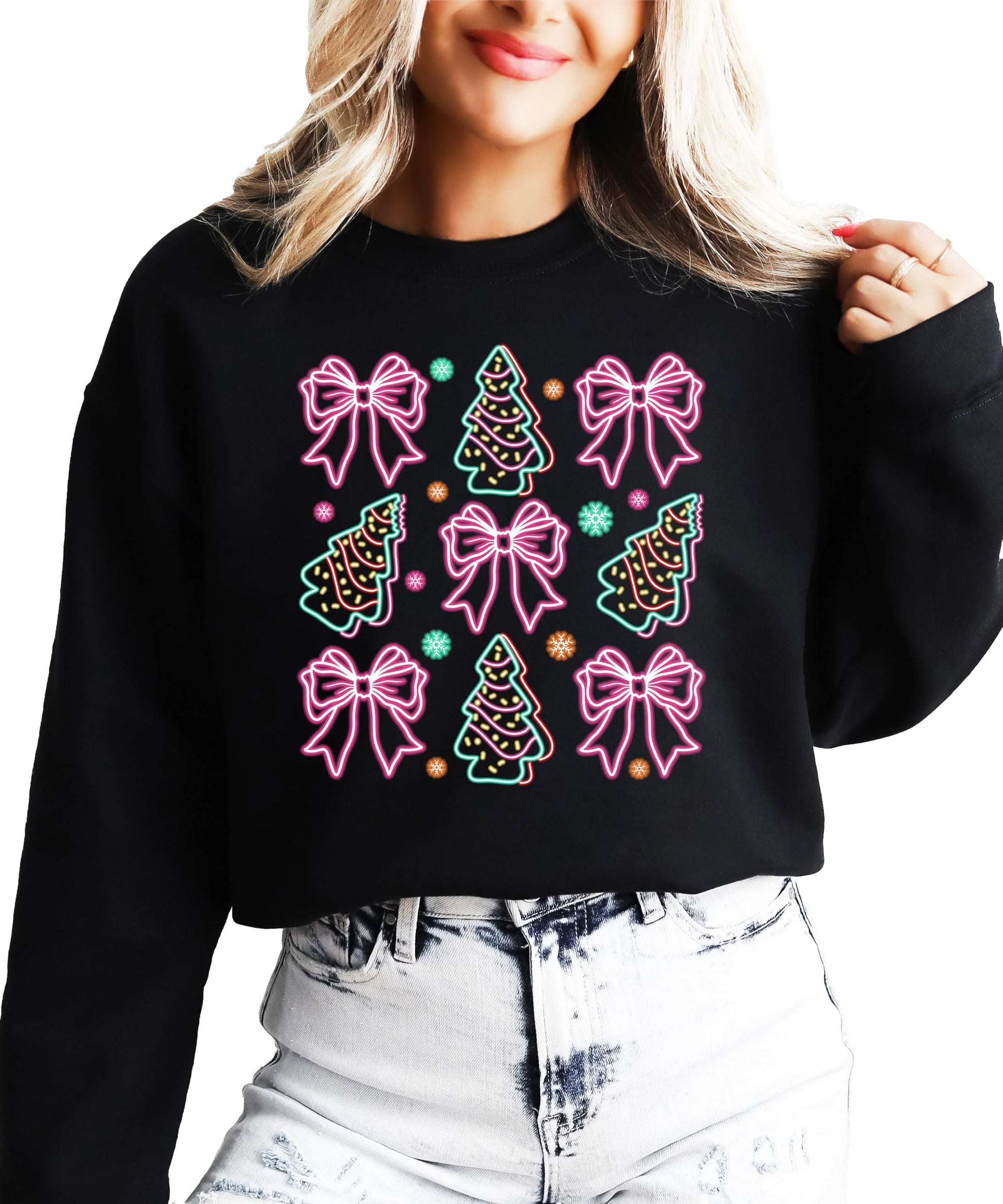 Lifestyle view of women's black Christmas sweatshirt with vibrant neon bow and tree holiday design