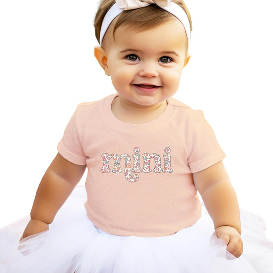 Woman wearing pink Mama floral graphic tee from Olive Loves Apple mommy and me collection