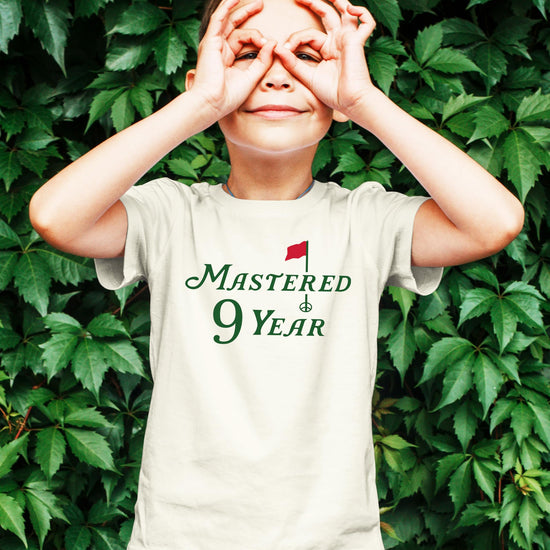 Close-up of Mastered 9 Years golf graphic print on kids birthday t-shirt