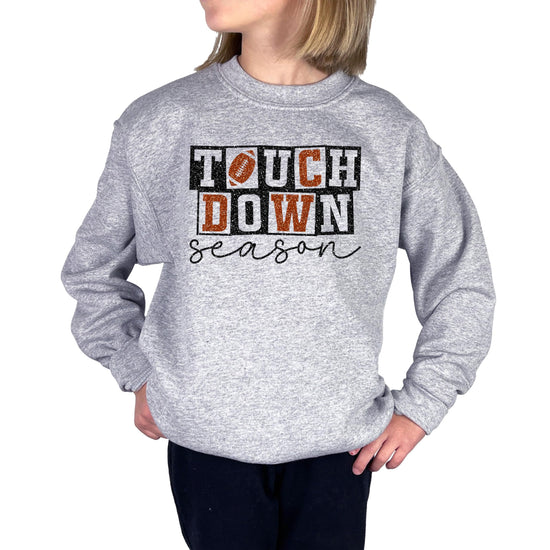 Grey pullover sweatshirt with faux glitter football touchdown season graphic for girls and women