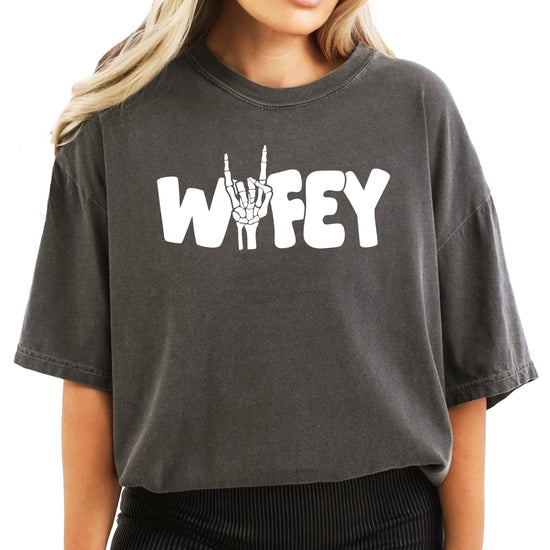 Side view of woman modeling Wifey skeleton Halloween graphic tee