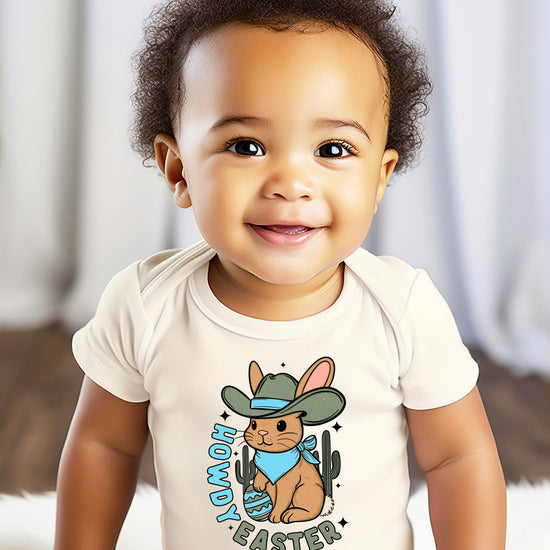 Detail view of Easter cowboy bunny graphic on natural baby bodysuit