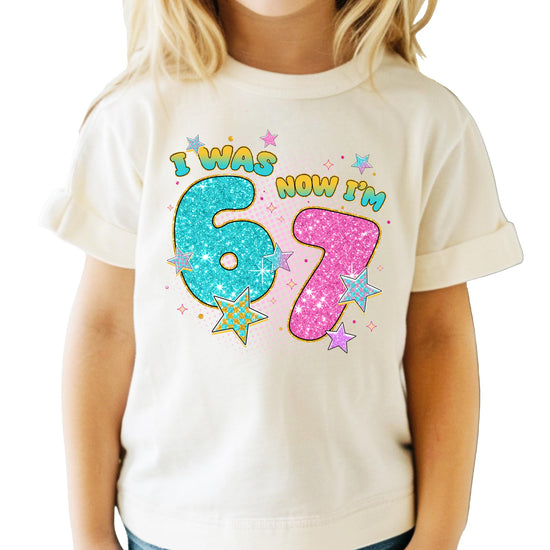 Front view of girls' 7th birthday pink glitter graphic tee by Olive Loves Apple