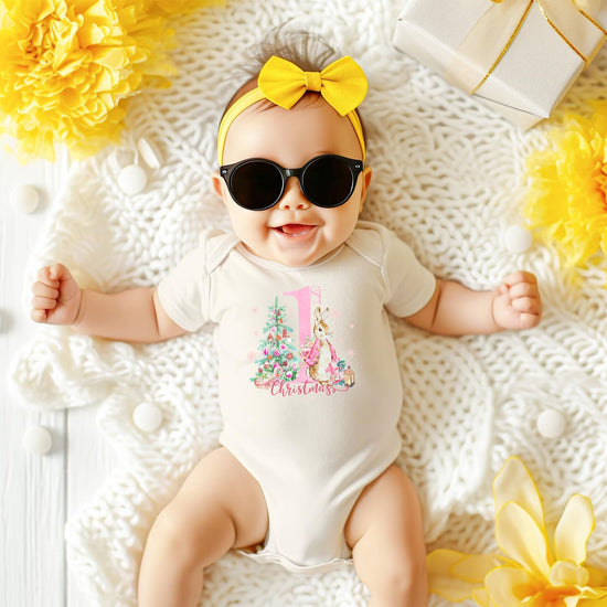 Baby girl First Christmas bunny bodysuit displayed as a holiday gift or keepsake