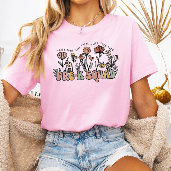 Woman wearing Pre-K Squad floral teacher tee in peach casual fit