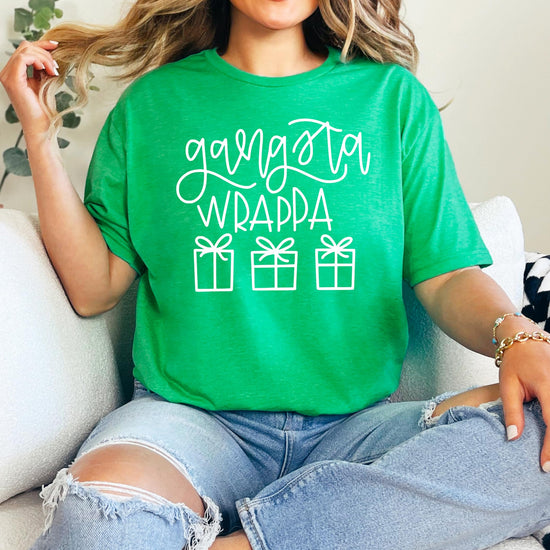 Close-up of Gangsta Wrappa holiday graphic print on red women's Christmas tee